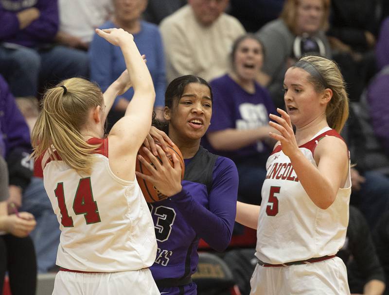 Dixon’s Ahmyrie McGowan is guarded by Lincoln’s Jenna Bowman (left) and Kloe Froebe in the class 3A super sectional Monday, Feb. 26, 2024 at LaSalle-Peru High School.
