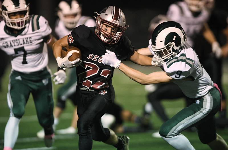 Antioch's Reino Hill grabs the facemark of Grayslake Central's Garrett Guenther as he tries to get past him in a football game in Antioch on Friday, October 8, 2021.