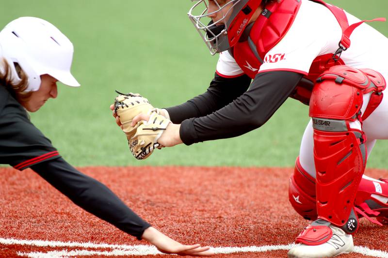 Barrington’s catcher Patrick Podlesnik, right, prepares to tag out Huntley’s Jason Wolter at home plate in varsity baseball at Barrington Saturday.