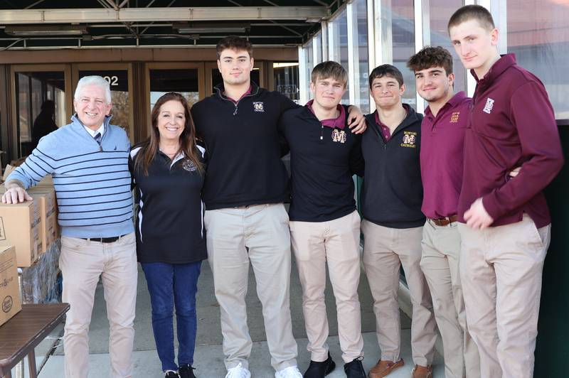 Pictured from left are Campus Minister Mike Blanchette, York Township's director of general assistance Pan Sarno, Montini Catholic students JC Hayes, George Asay, Alex Marre, Sam Ostrowski and Jimmy Fitzpatrick
