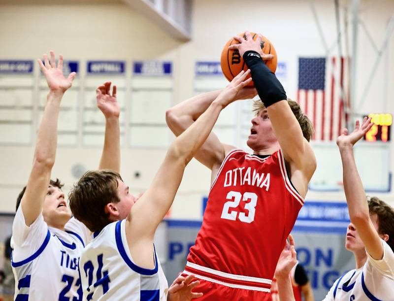 Ottawa's Owen Sanders shoots over Princeton Tigers Hayden Sayler (23) and Ryan Jagers (24) Tuesday night at Prouty Gym. The Pirates won 73-43.