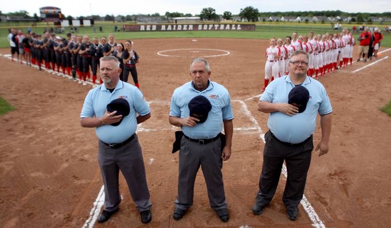Umpires and teams line up for the national anthem before the Class 4A Huntley Sectional championship, Saturday, June 4, 2022.