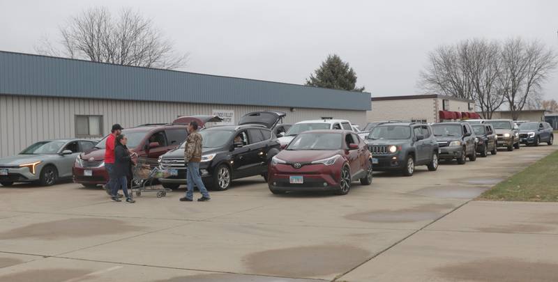 A long line of cars wait for orders during the Thanksgiving Distribution on Wednesday, Nov. 19, 2025 at the Illinois Valley Food Pantry in Peru. Nearly 500 families or roughly 1,200 people in the Illinois Valley got a Thanksgiving meal.