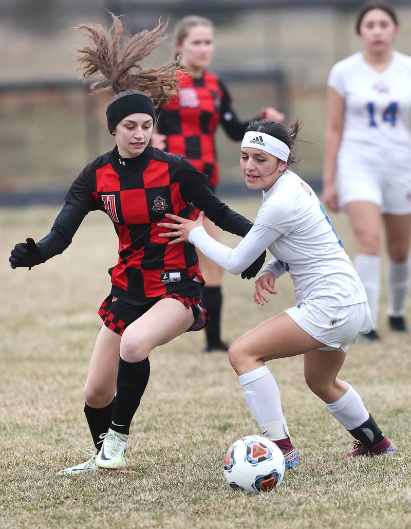 Indian Creek's Izzy Turner (left) and Genoa-Kingston's Anna Martinez run down the ball during their game Thursday, March 16, 2023, at Pack Park Sports Complex in Waterman.