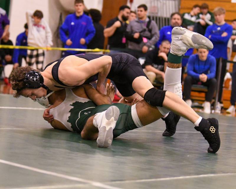 Donny Pigoni of Marmion Academy, top, competes in the regional title match against Glenbard West Alejandro Aranda where Donny took the win in the 126 weight class on Saturday Feb. 3, 2024, held at Glenbard West High School.