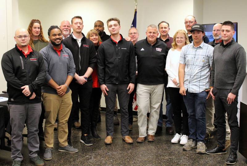 Staff from Brian Bemis car dealership pose for a photograph during the Jan. 13, 2025, meeting of the DeKalb City Council.