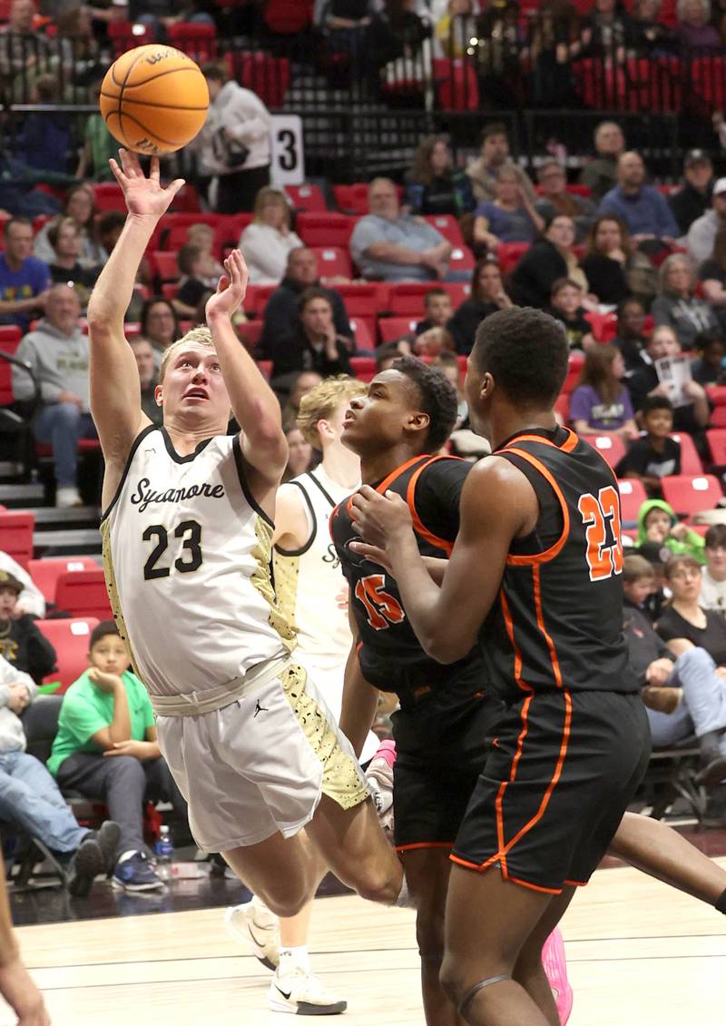 Sycamore's Carter York shoots over a pair of DeKalb defenders during their game Friday, Jan. 31, 2025, in the FNBO Challenge in the Convocation Center at Northern Illinois University in DeKalb.
