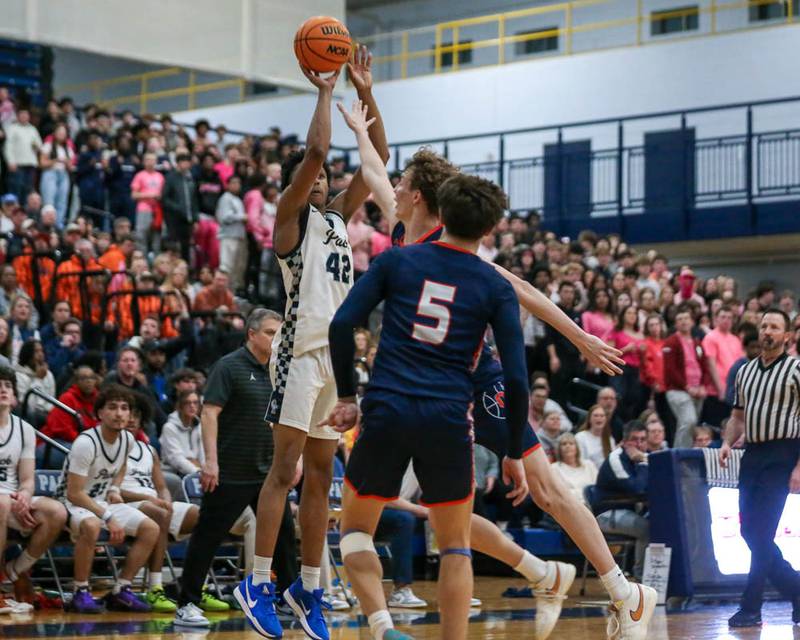 Oswego East's Dshaun Bolden (42) shoots a late jump shot during their basketball game between Oswego at Oswego East, Feb 13, 2026 in Oswego.