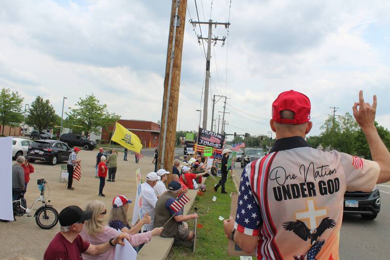 Attendees cheer at honking cars during the "Rally of the Silent Majority" showing support for President Donald Trump and the National Day of Prayer on May 17, 2026, in McHenry.
