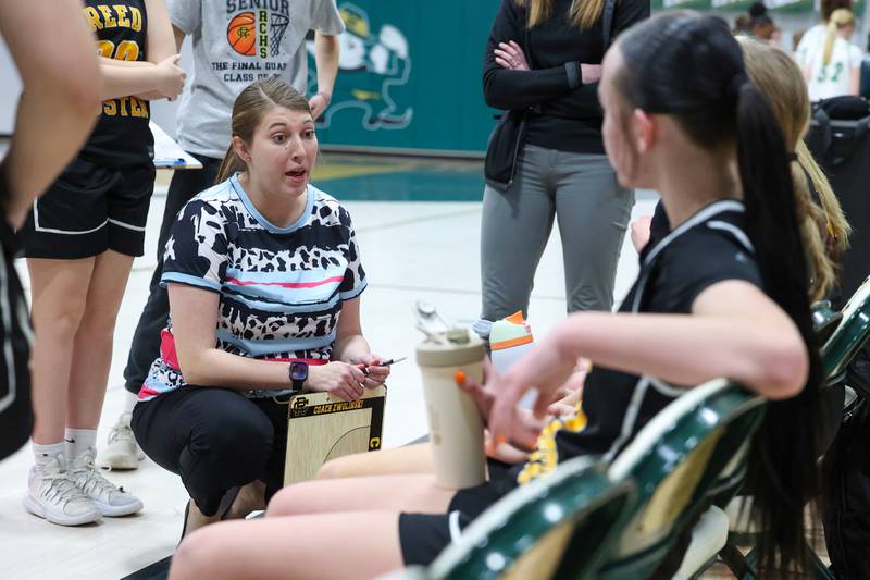 Reed-Custer head coach Shelby Zwolinski talks to her team in a timeout during Bishop McNamara's 60-36 victory over Reed-Custer in the IHSA Class 2A Bishop McNamara Regional semifinals on Monday, Feb. 16, 2026.