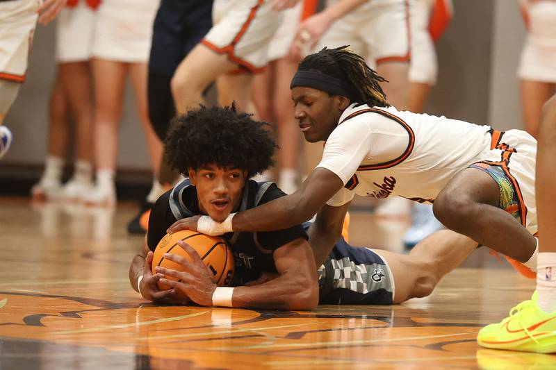 Oswego East’s Jacsen Tucker tries to keep the ball away from Minooka’s Nehemiah Brown on Friday, Jan. 16, 2026 in Minooka.