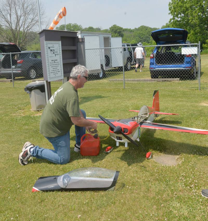 Lloyd McKenna of Prophetstown, pumps fuel into his model aircraft at the Morrison Model Aircraft Flyers area inside Morrison-Rockwood State Park on Sunday, June 4.