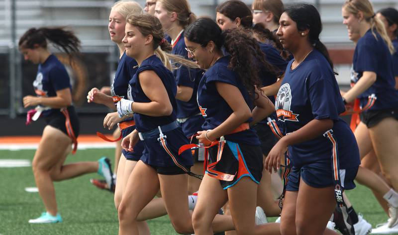 Athletes run through sprints as the Chicago Bears and McHenry Community High School hosted a flag football clinic at McCracken Field Wednesday, July 31, 2024.