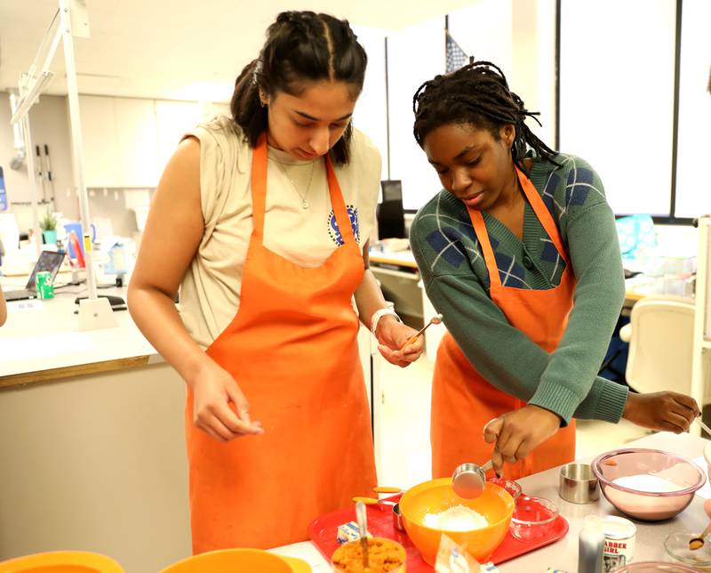 Geneva High School students Rishika Goyal (left) and Stephanie Edeh (right) gather their ingredients to make pumpkin chocolate chip cookies as part of the school’s Vikings WIN – which stands for What I Need – program on Friday, Sept. 29, 2023.