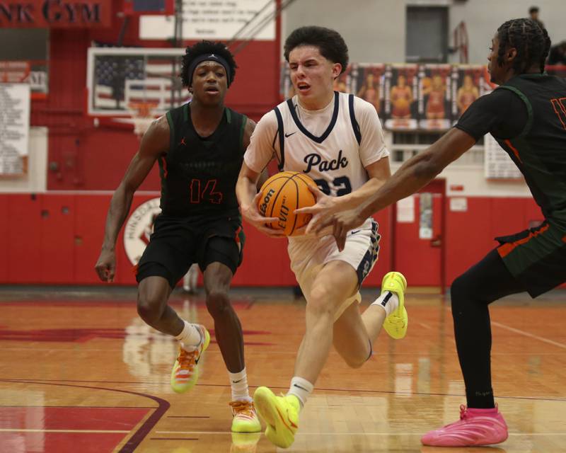 Oswego East's Noah Yu (22) drives to the basket during their Hinsdale Central Holiday Classic basketball game between Morgan Park at Oswego East Saturday, Dec 27, 2025 in Hinsdale.
