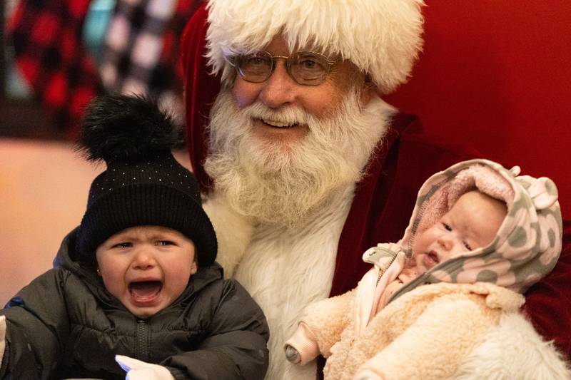 Brooklyn, 2, and Hailey, 3 months, Mclearen pose for a photo with Santa during the Celebration of Lights at the Batavia Riverwalk on Sunday, Dec. 1, 2024.