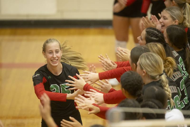 Aubery Duttlinger high fives her teammates prior to the start of the home match against Sycamore on September 14, 2023.
