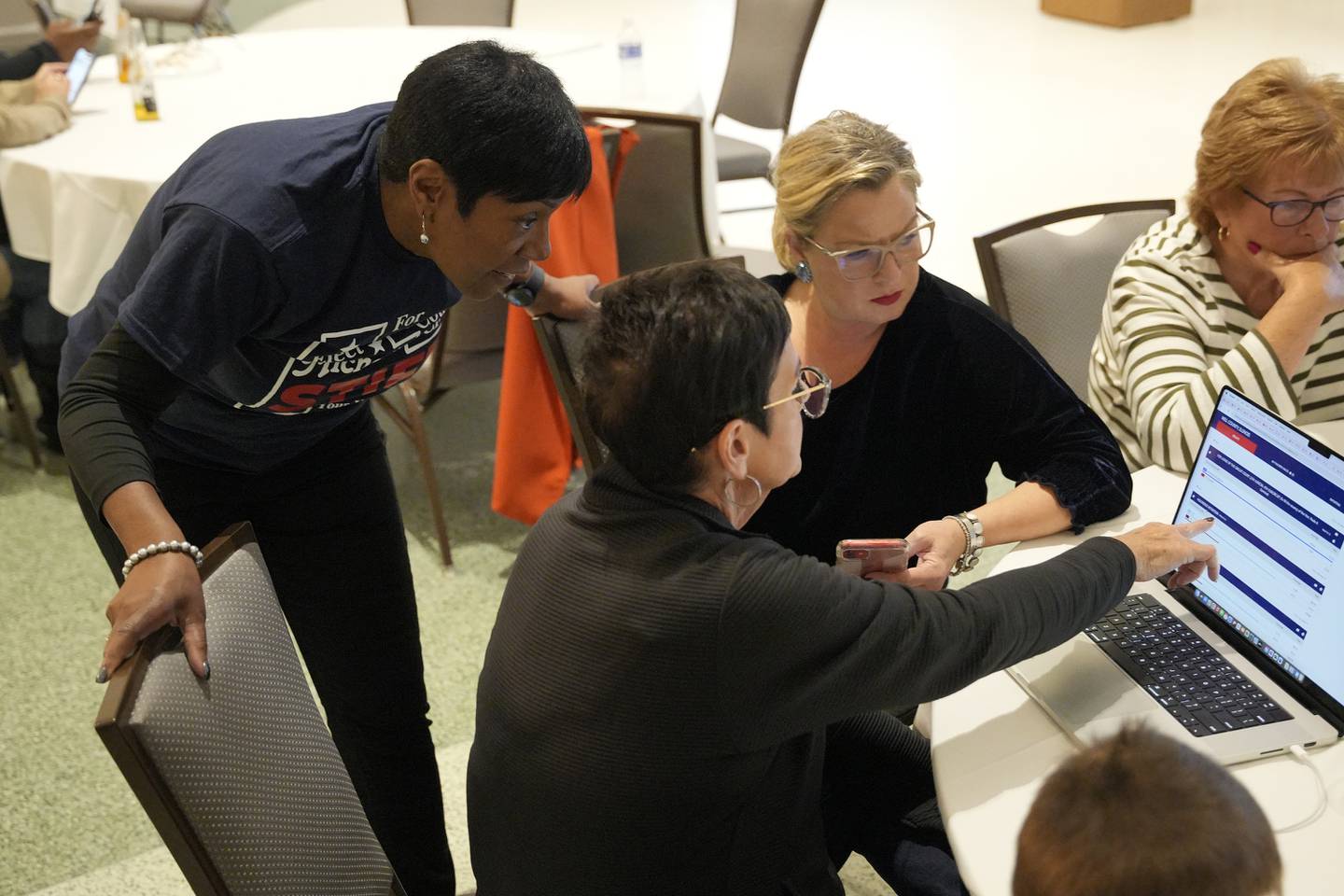 Michelle Stiff, from left, Deputy Majority Leader State Representative Natalie Manley, and Erin Gallagher are seen at the Democratic watch party at IBEW Local 176 hall on Tuesday Nov. 5, 2024 in Joliet, Ill.