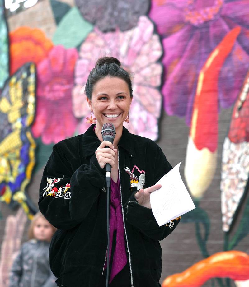Mural artist Danielle Casali speaks Thursday, Oct. 19, 2023, during the unveiling and ribbon cutting of the new City Hall mural she created. The mural is on the on the south wall of City Hall and was completed with the help of many volunteers who wanted to be a part of the project..
