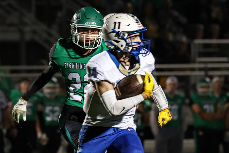 Kyle Stanislo of Aurora Central Catholic runs ball whilst Brayden Simek of Seneca trails on Friday, September 27, 2024 at Seneca high school in Seneca.