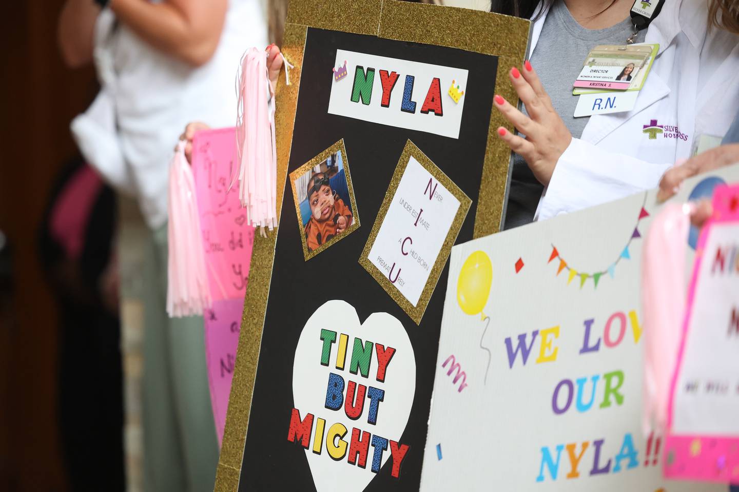 A staff member holds a sign as Nakeya and Cory Haywood leave the hospital with their daughter Nyla during a send off party at Silver Cross Hospital on Monday, May 13, 2024 in New Lenox. Nyla is the youngest preemie, born Nov. 17, 2023, at 22 weeks and 3 days, weighing 1.1 pounds, Silver Cross Hospital’s NICU has cared for.