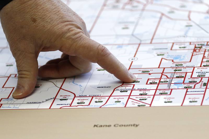 McHenry County board member Joe Gottemoller shows a current map of McHenry County voter districts and precincts on Friday, April 30, 2021 in Crystal Lake. The county is considering redistricting and is awaiting updated census information.