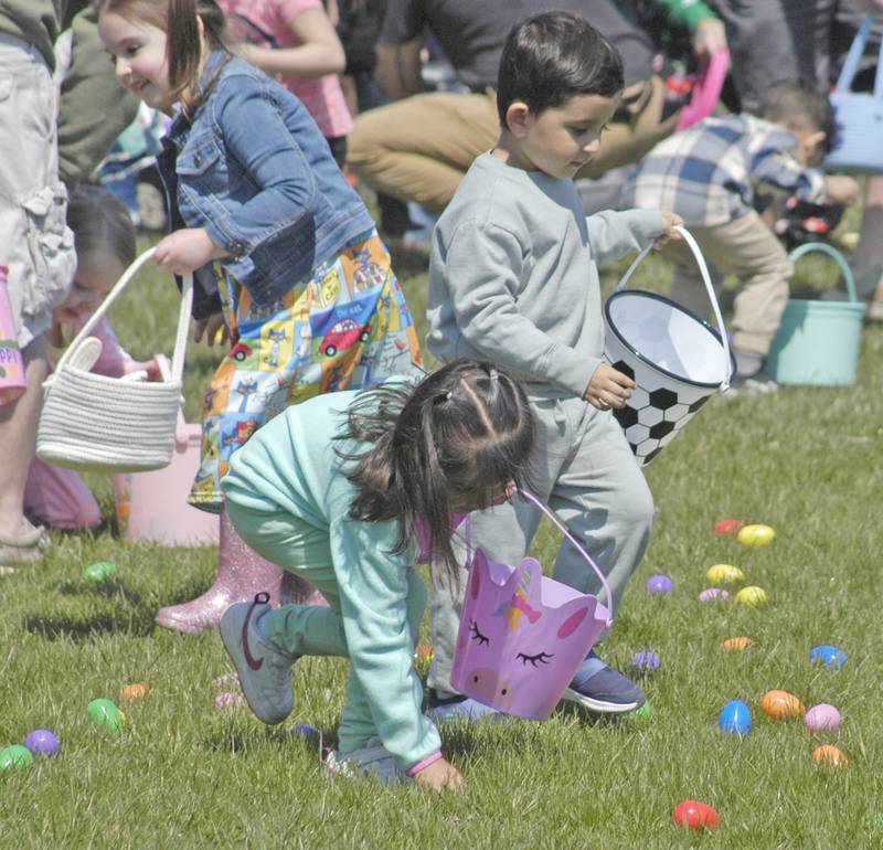 Kids pick up plastic eggs at the beginning of the Eggstravaganza Egg Hunt, sponsored by the Dixon Park District, at the park facilities on Saturday, April 12, 2025.