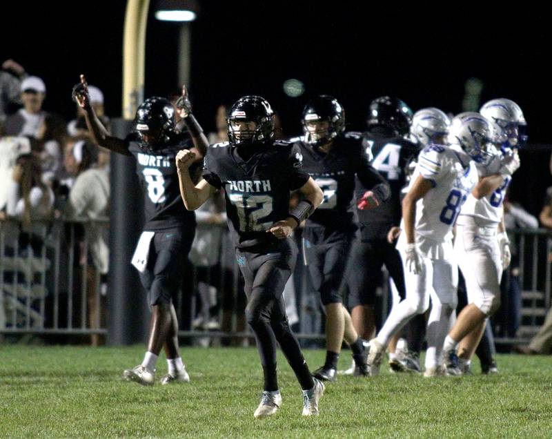 Woodstock North’s Landan Creighton, center, pumps his fist after running in a 96-yard touchdown against Woodstock in varsity football at Woodstock North Friday night.