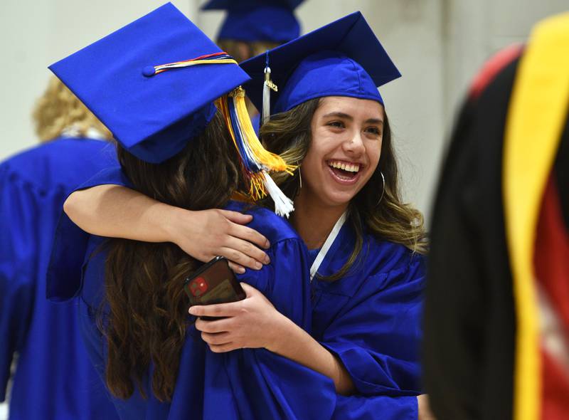 Geneva High School senior Kyla Reyes, right, gets a hug from a fellow graduate during their commencement ceremony on Tuesday, May 30, 2023 at Northern Illinois University in DeKalb.