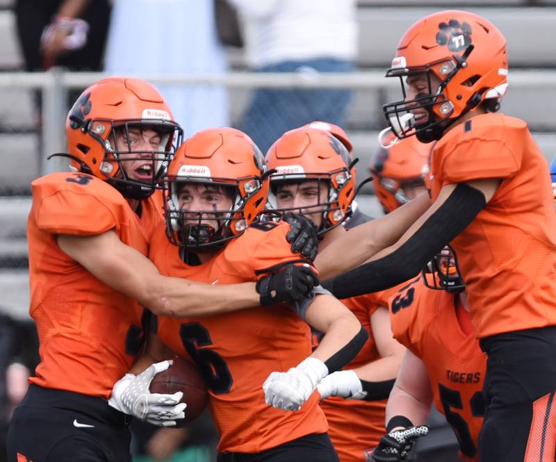 Joe Lewnard/jlewnard@dailyherald.com
Wheaton Warrenville South’s Maison Haas, middle, celebrates a second-quarter inteception with teammates during Saturday’s game against Simeon.
