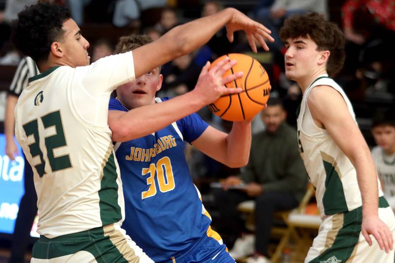 Johnsburg’s Jayce Schmitt navigates heavy traffic against Boylan in varsity boys basketball Hinkle Holiday Classic action on Tuesday, Dec. 23, 2025, at Jacobs High School in Algonquin.