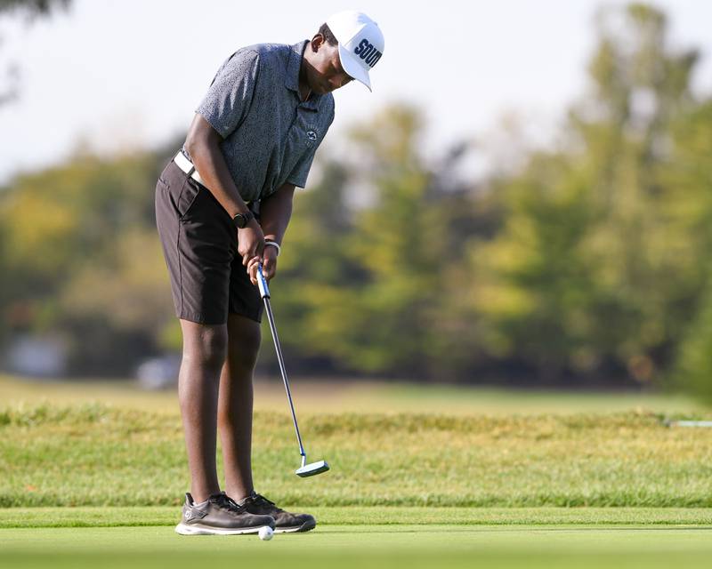 Jonah Powell of Plainfield South watches as he sinks a putt during the Plainfield Central regional held at Wedgewood Golf Course in Plainfield.