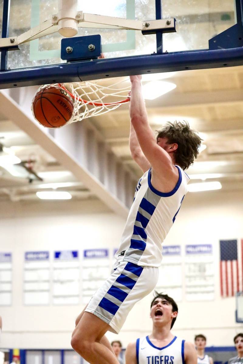 Princeton's Teegan Davis throws down a dunk against Newman Friday night at Prouty Gym. He scored 29 points to lead the Tigers to a 80-32 win.