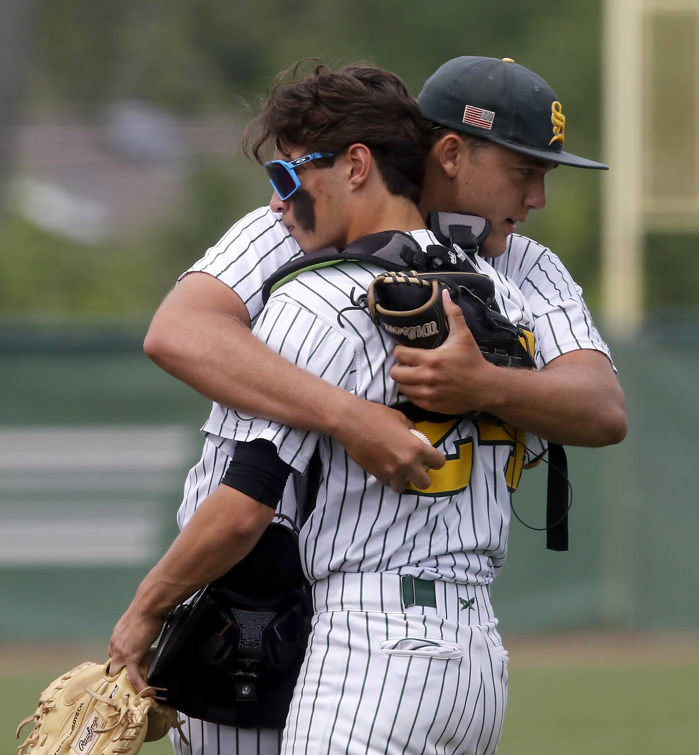 Crystal Lake South's Devin De Loach hugs his catcher, Jackson Lee, as they take the filed for the IHSA Class 3A Grayslake Central Sectional Championship baseball game against Cary-Grove on Saturday, June 7, 2025, at Grayslake Central High School.