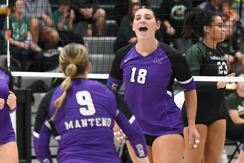 Manteno's Maddie Gesky, right, jubilantly looks towards Panthers teammate Leah Donnelly after a point scored at Bishop McNamara Monday, Oct. 20, 2025.