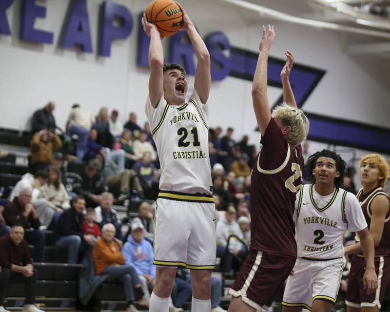 Yorkville Christian's Jordan Purvis (21) goes back up after grabbing a rebound during their Plano Christmas Classic basketball game between Morris at Yorkville Christian Friday, Dec 26, 2025 in Plano.