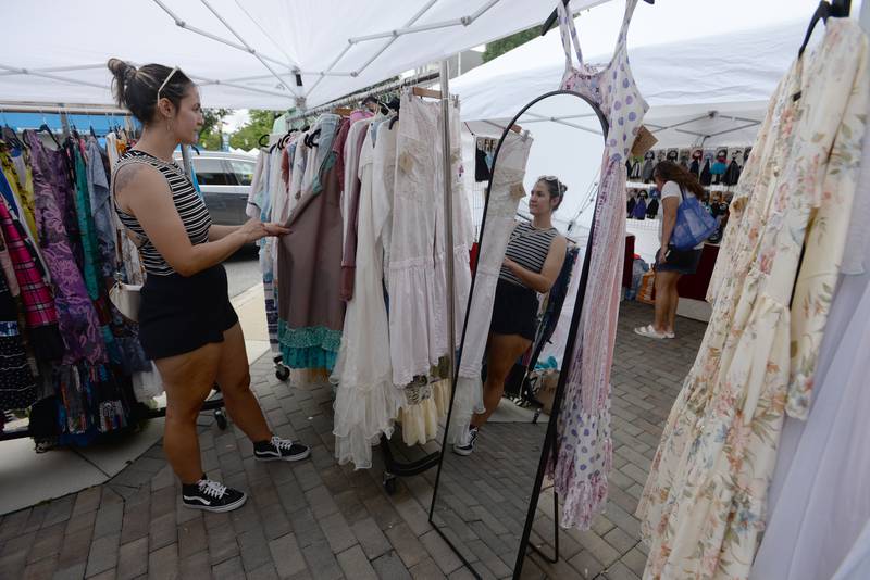 Alice Cordero of Brookfield admires some of the dresses for sale during the annual La Grange Craft Fair Saturday July 12, 2025.