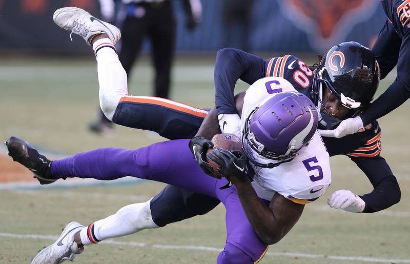 Chicago Bears cornerback Harrison Hand brings down Minnesota Vikings wide receiver Jalen Reagor Sunday, Jan. 8, 2023, during their game at Soldier Field in Chicago.