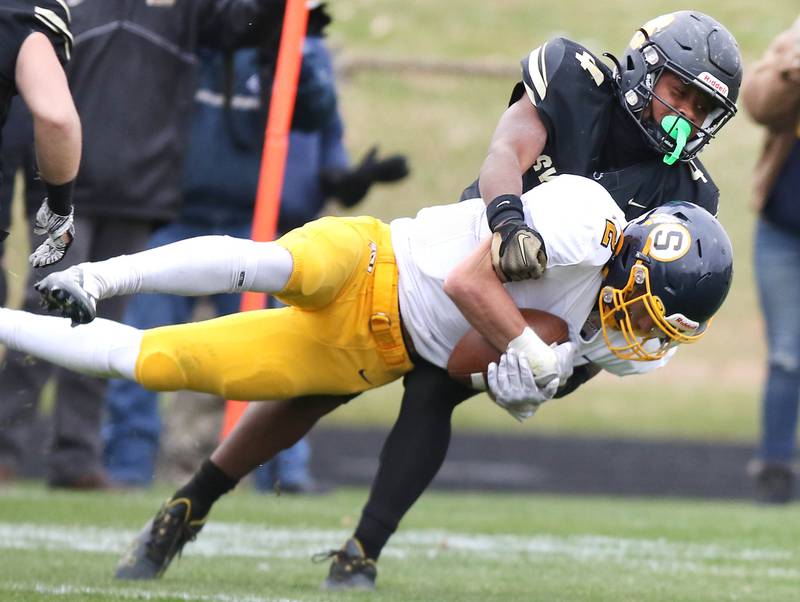Sycamore's Tyler Curtis brings down Sterling's JP Schilling during their Class 5A state playoff game Saturday, Nov. 12, 2022, at Sycamore High School.