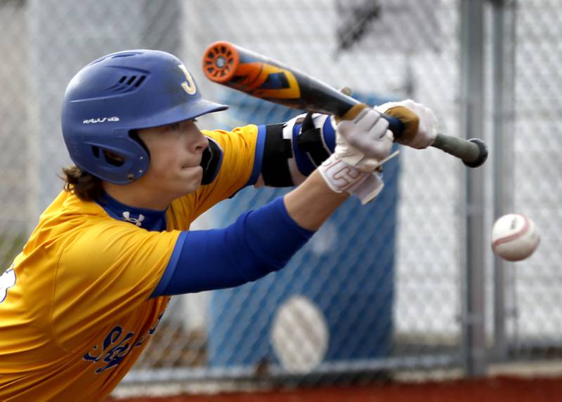 Johnsburg's Evan Pohl gets a bunt down to advance the runners during a Kishwaukee River Conference baseball game against Marengo on Monday, April 21, 2025, at Johnsburg High School.