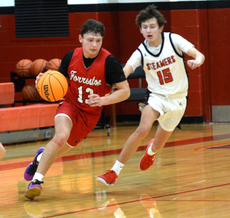 Forreston's Kendall Erdmann (13) dribbles up court as Fulton's Owen VanZuiden (15) defends during a Friday, Dec. 27, 2024 game at the Cliff Warkins Memorial Basketball Tournament at Erie High School.