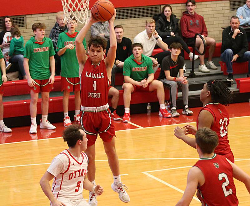 L-P's Jack Jereb grabs a rebound over Ottawa's Levi Sheehan in Kingman Gymnasium on Friday, Feb. 10, 2023 at Ottawa High School.