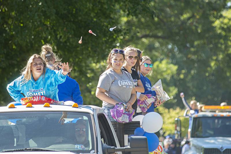 The Newman girls tennis team throws candy from their float during the school’s homecoming parade Friday, Sept. 30, 2022.