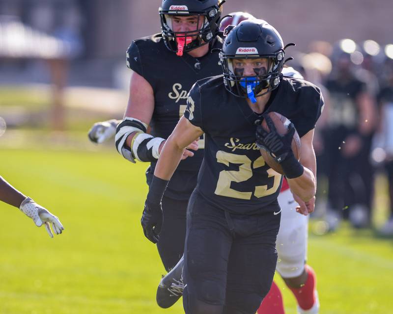 Sycamore's Dylan Hodges (23) runs the ball before being tackled short of the goal line by a Chicago Bulls College Prep defenders on Saturday Nov. 2, 2024, during the class 5A playoff game held at Sycamore High School.