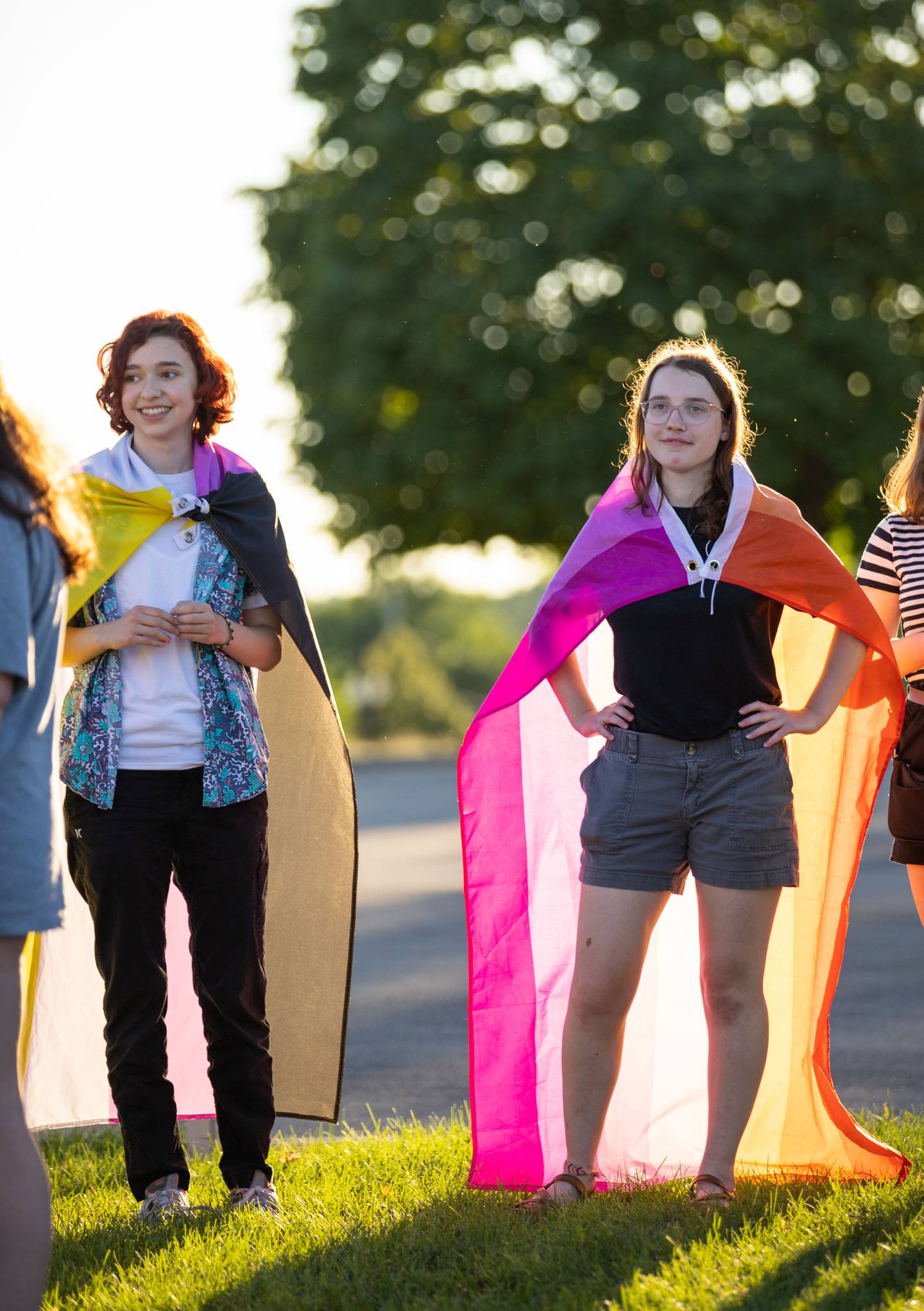 Alex Kellick, 17, (left) and Allie Morris, 17, wear pride flags  during the Pride Fire Hydrant Rally at the northwest corner of Kirk Road and State Street/Rte. 38 in Geneva on Tuesday, Aug. 9, 2022.