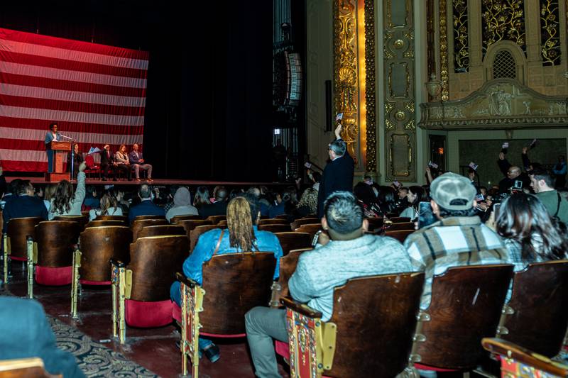New U.S. citizens stand as U.S. Congresswoman Lauren Underwood reads off the countries represented during the Naturalization Ceremony at Rialto Square Theatre in Joliet on April 17, 2025.