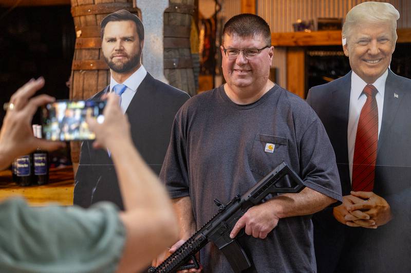 Jeff Allen poses with BB gun for photo at 'Guns Save Life' event on Thursday, Aug 21, 2025 at Jamie's Outpost in Utica.