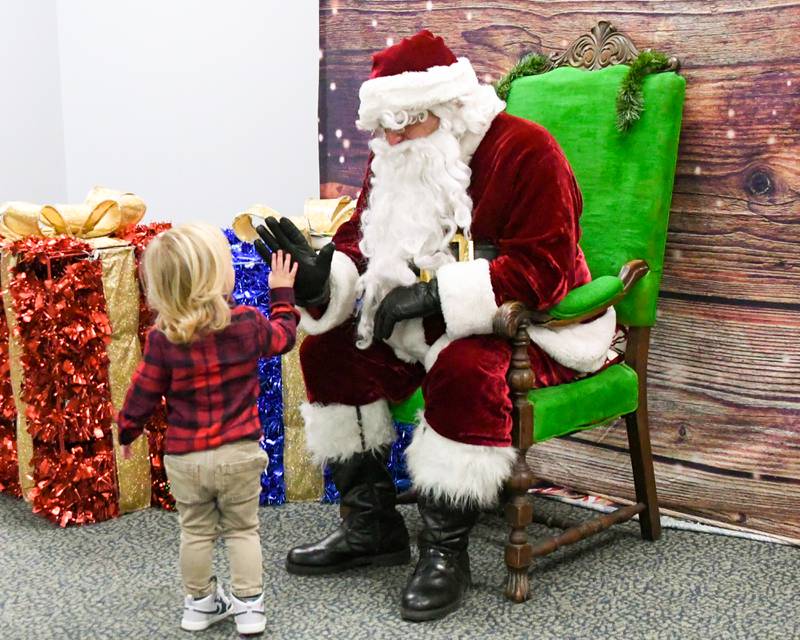 Quinton Lynch, 2, of La Grange gives Santa a high five before leaving the breakfast with Santa event on Sunday Dec. 15, 2024, held at the La Grange Park District Recreation Center.