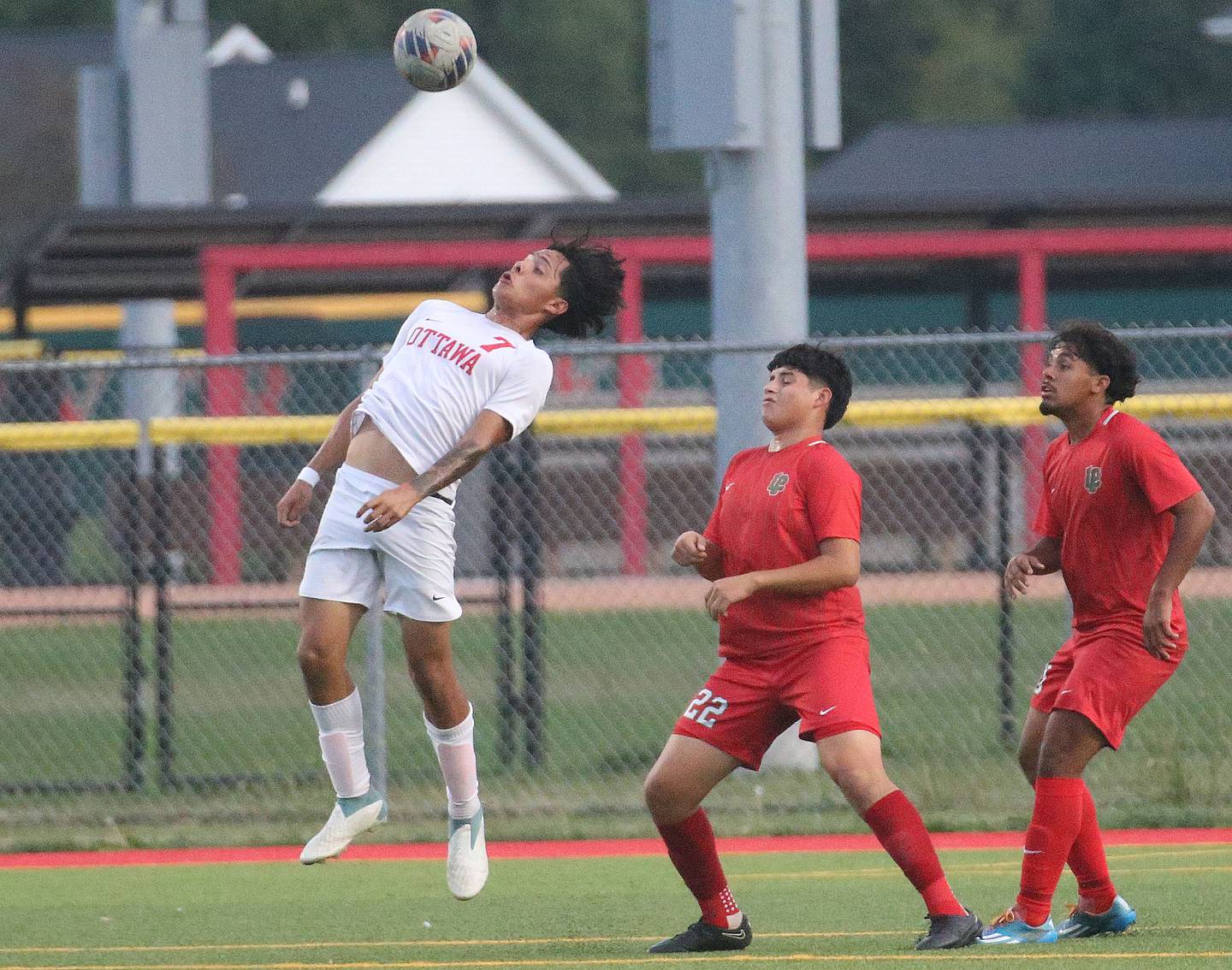 Ottawa's Jorge Lopez knocks the ball down against L-P's Damian Cortes and teammate Noah Escobedo on Monday, Oct. 6, 2025 at the L-P Athletic Complex in La Salle.