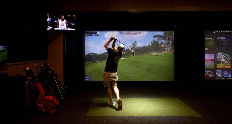 Bill Birkmeier of Huntley plays indoor golf during a patio launch party at Pickle Haus in Algonquin Friday night.